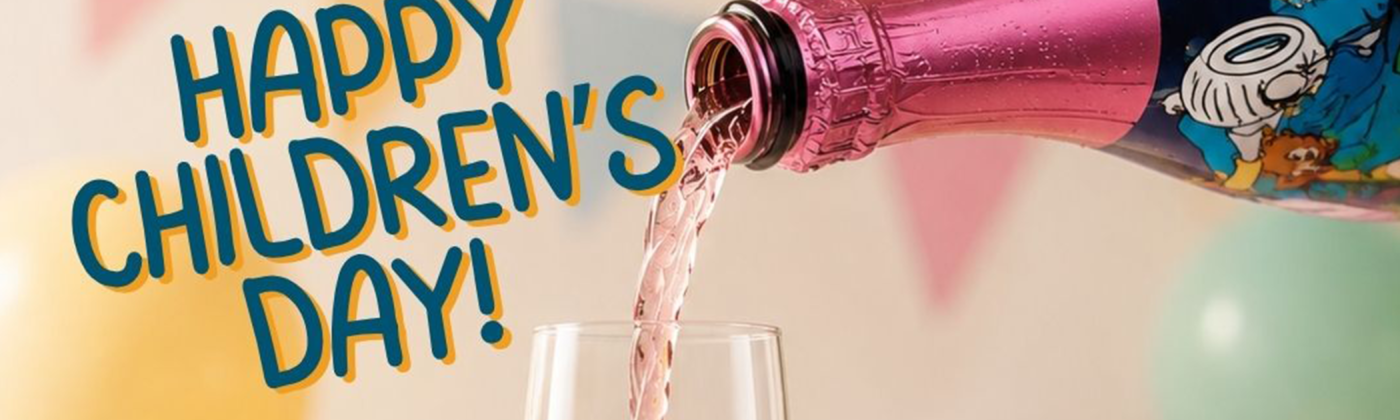 Happy Children's Day celebration with a sparkling pink soft drink being poured into a champagne glass